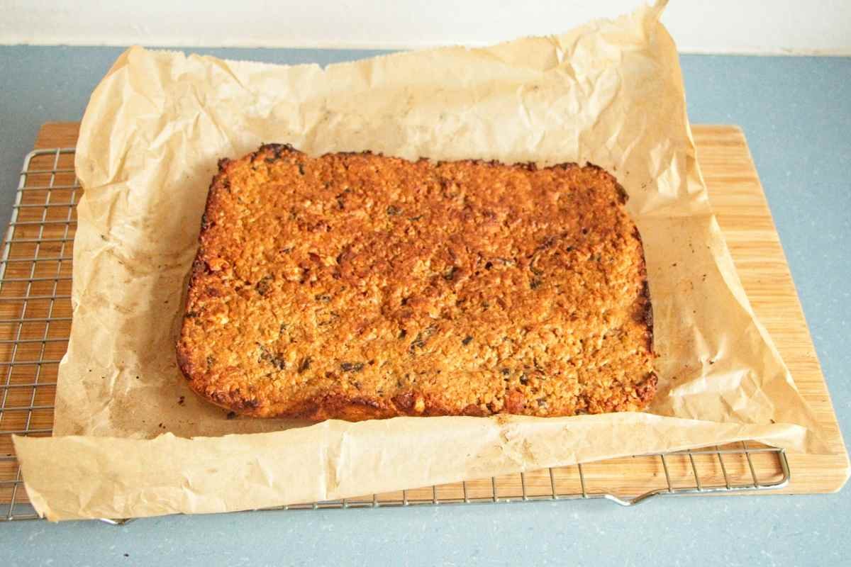golden baked oat flapjack slab cooling on parchment paper