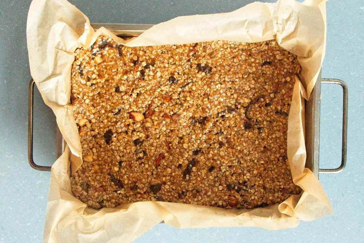 oat mixture pressed firmly into a lined baking dish before baking