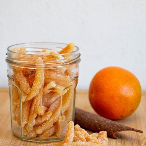 Homemade candied orange peel with cinnamon stored in a glass jar