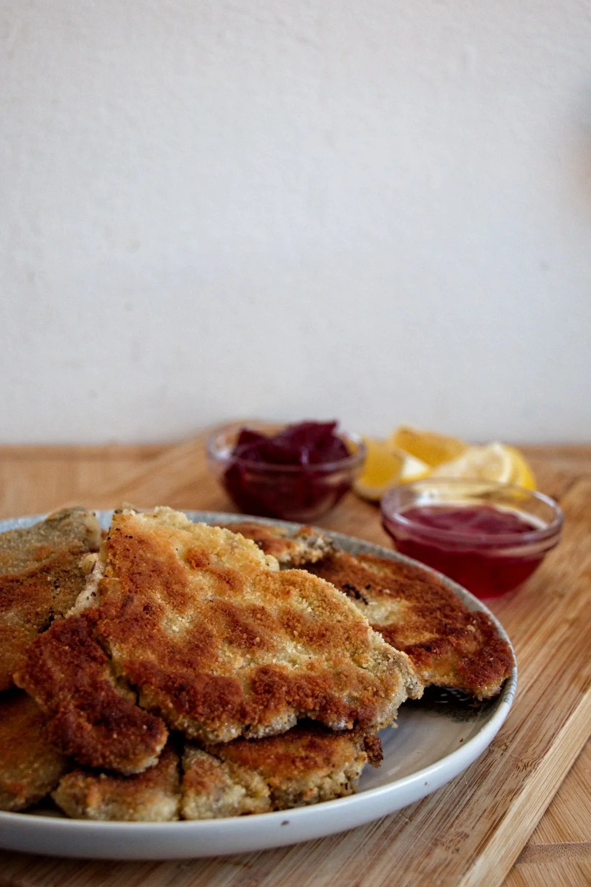 Crispy breaded parasol mushrooms served with lemon wedges and cornelian cherry jelly and lingonberry jam