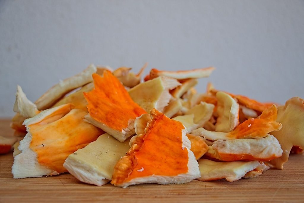 Fresh chicken of the woods mushrooms on a cutting board, ready for cooking