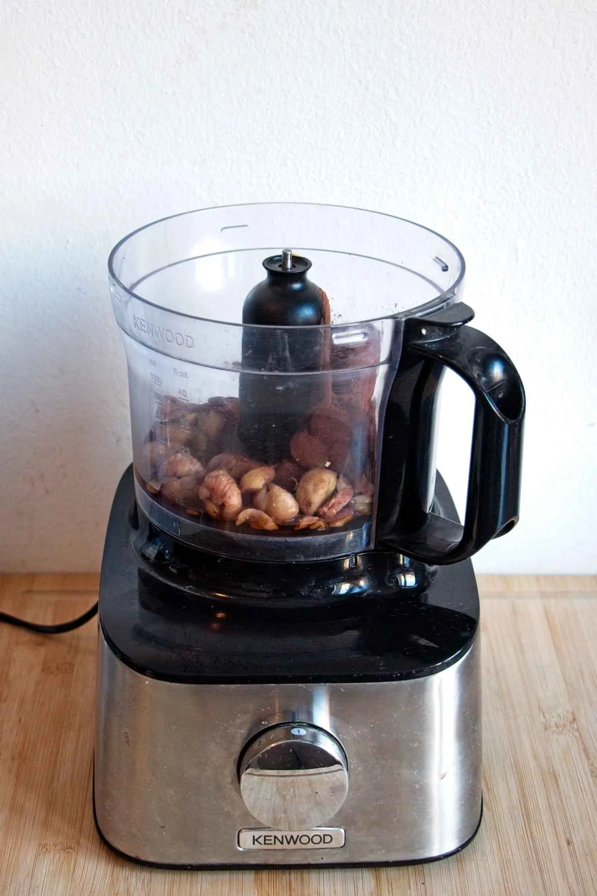 Chestnuts sitting in a food processor bowl before blending.