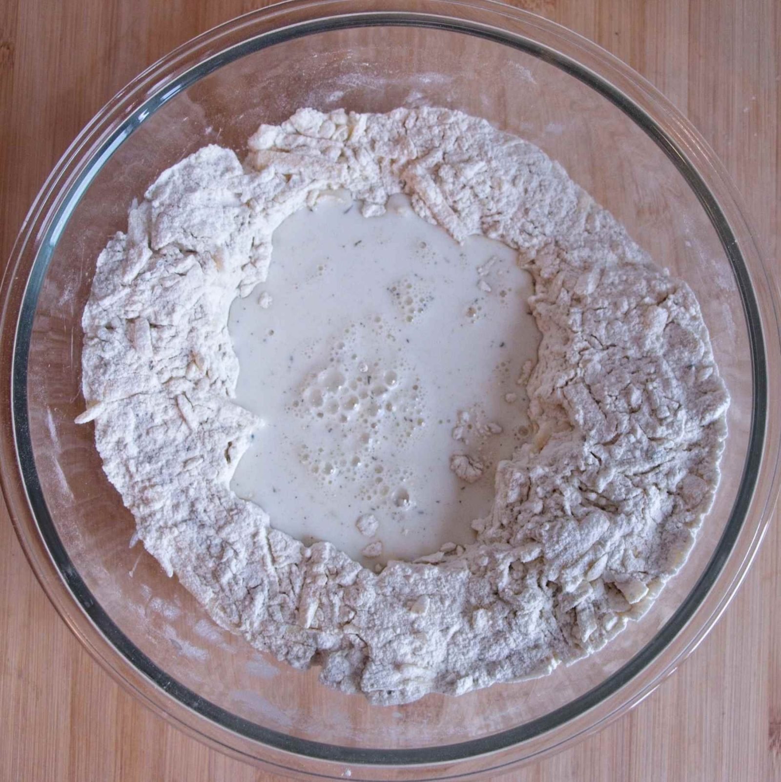 Buttermilk added to a well in the dry ingredients before mixing the soda bread dough.