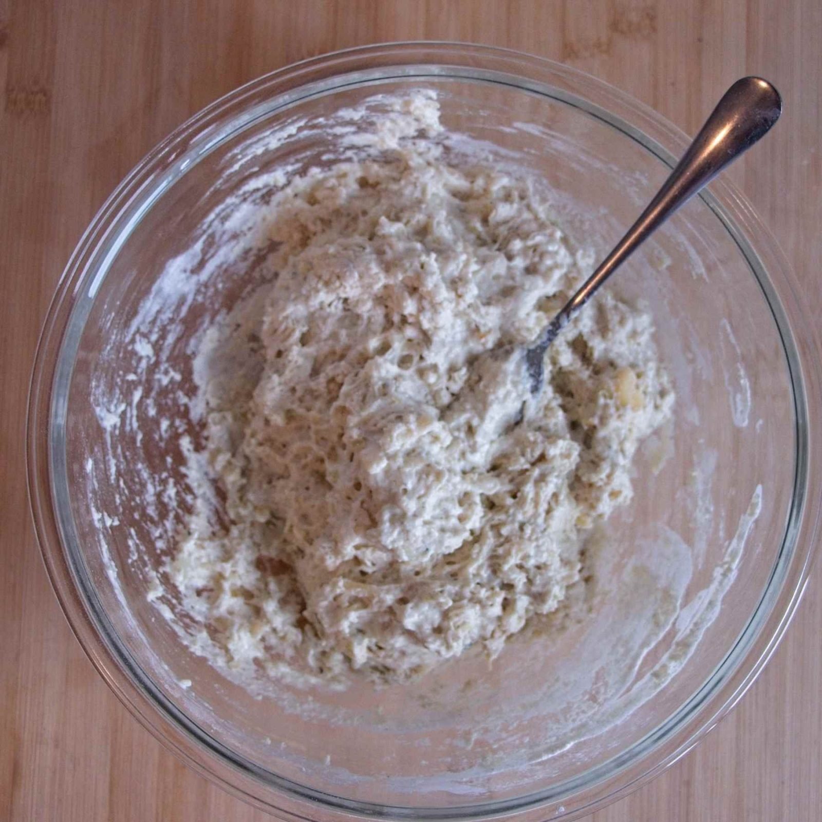Soft, sticky soda bread dough mixed in a bowl, ready to be shaped before baking.