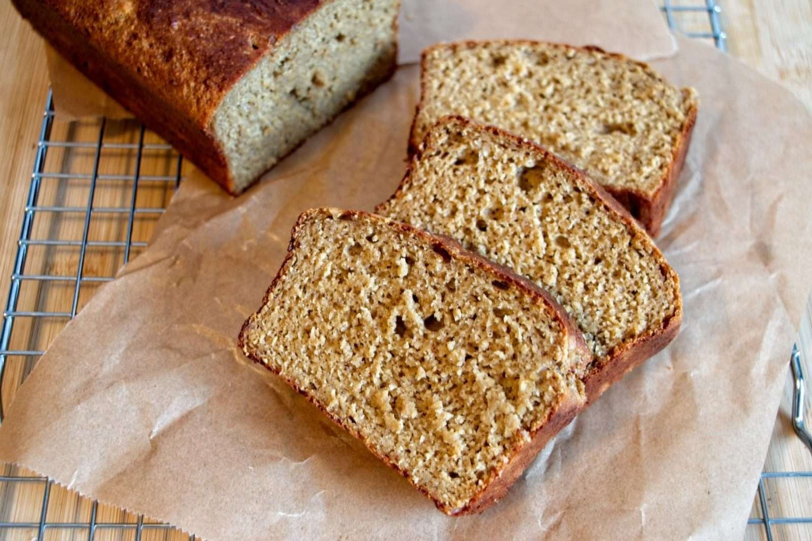 Close-up of sliced protein banana bread with cottage cheese on a cooling rack.