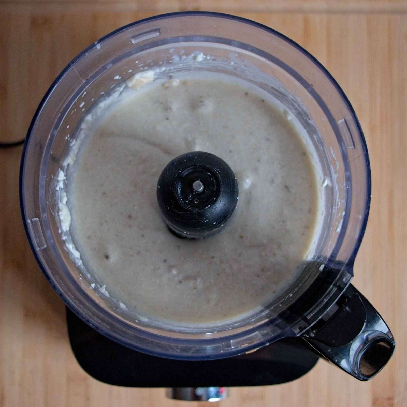 A food processor filled with a smooth blended batter.