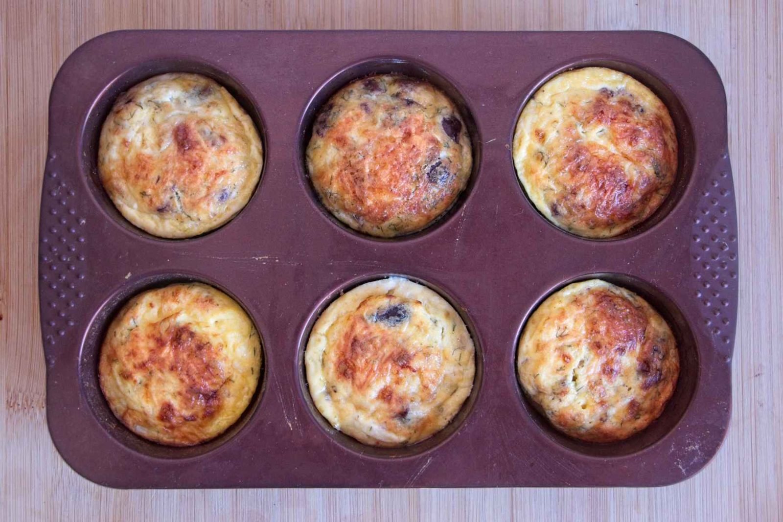 Baked cottage cheese muffins set and lightly golden in a muffin tin