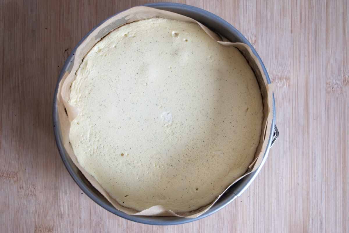 Protein cheesecake without protein powder baked in a lined cake tin, just set and ready to cool