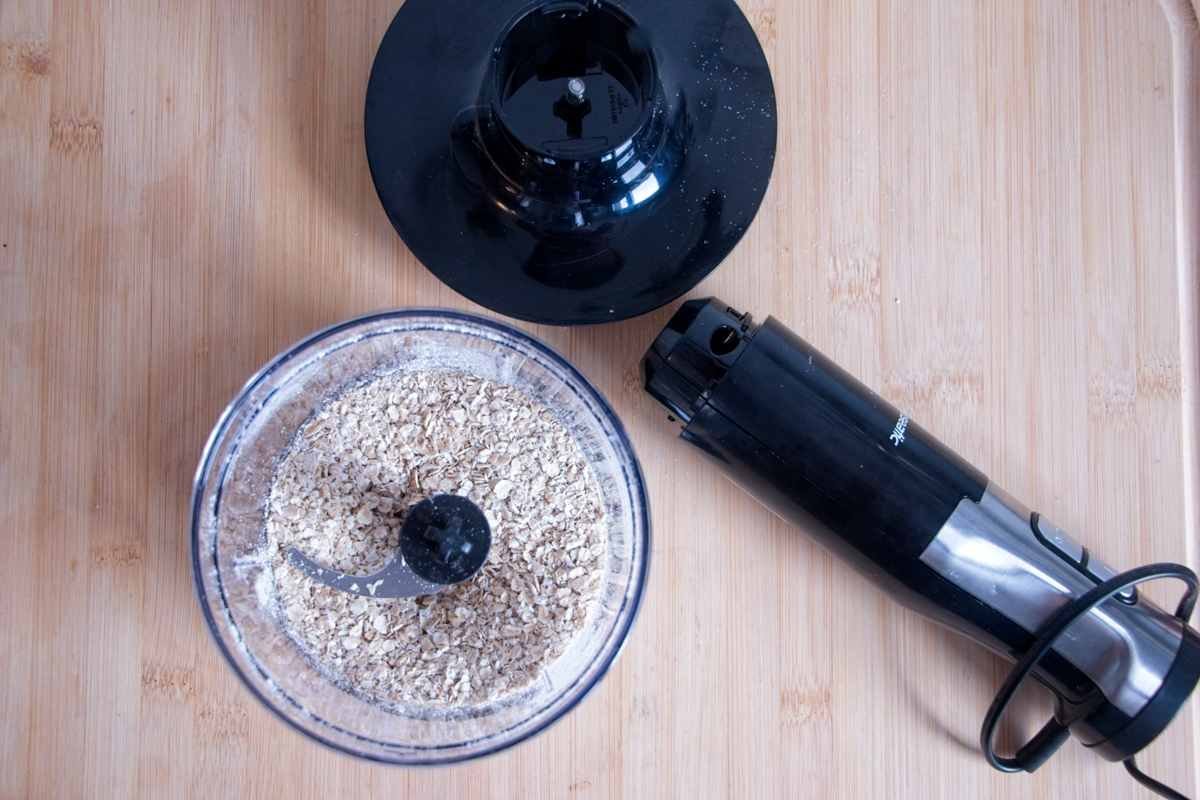 Blending rolled oats in a food processor to make a fine base for the cheesecake