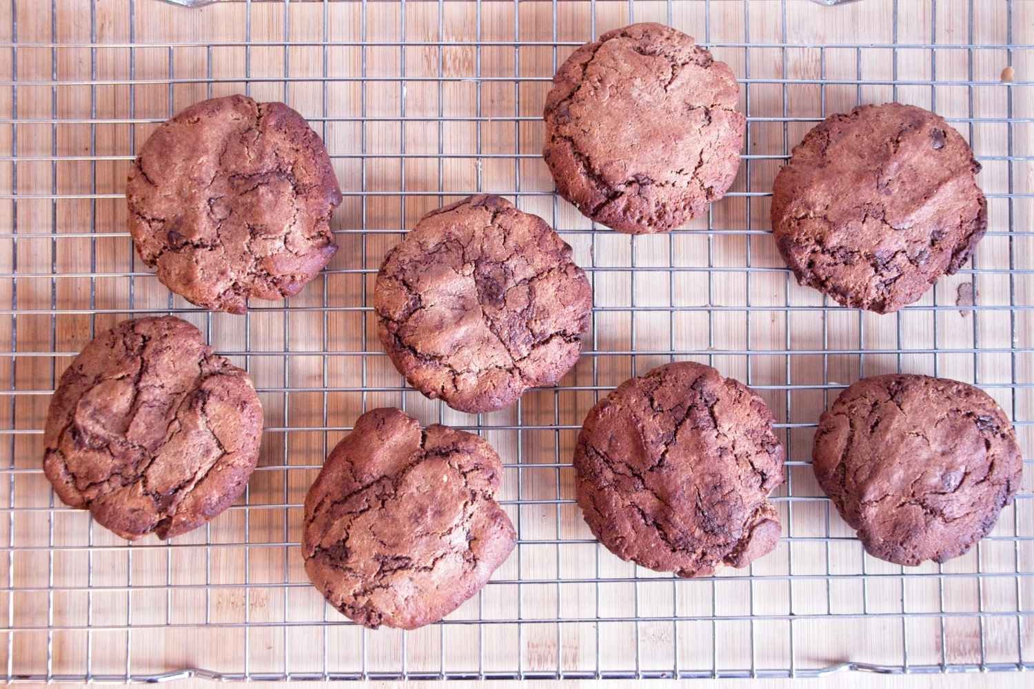 Chocolate peanut butter protein cookies cooling on a wire rack after baking