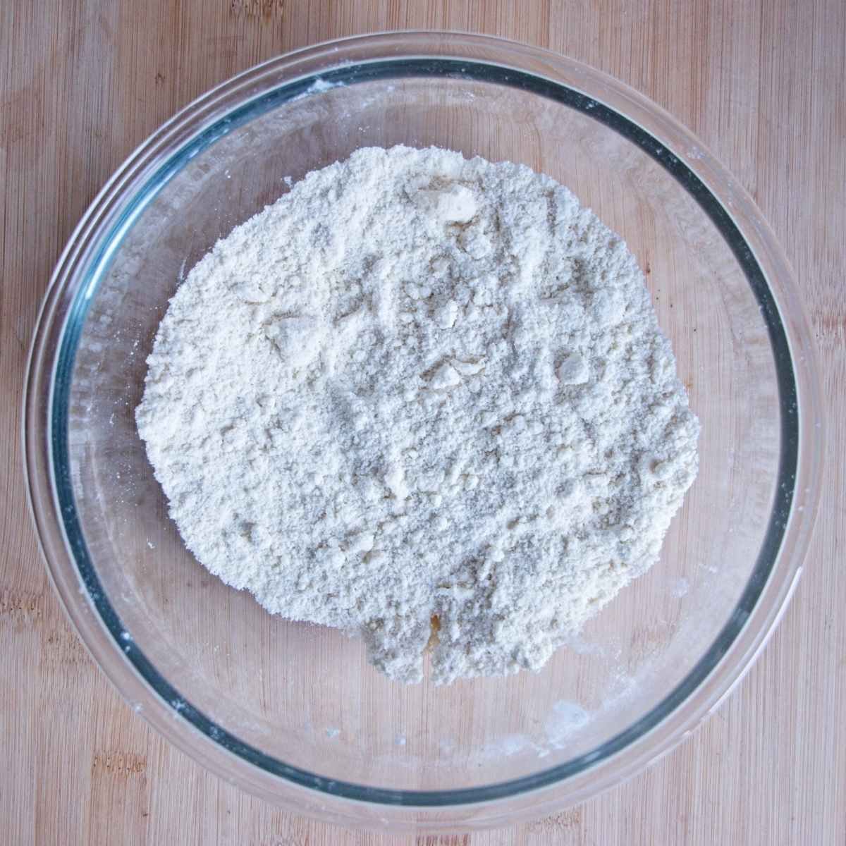 Plain flour and baking powder mixed together in a glass bowl