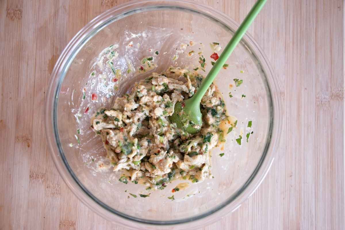 Mushroom cake mixture combined in a glass bowl before shaping.