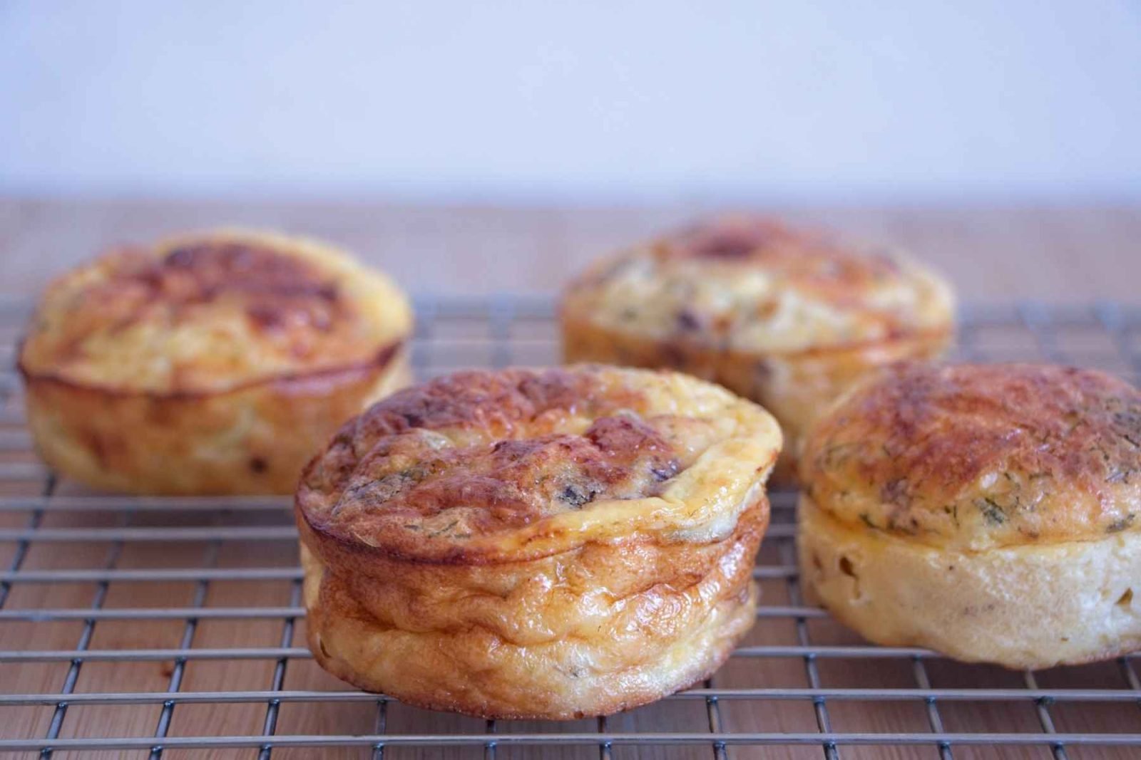 Low carb cottage cheese muffins cooling on a wire rack after baking