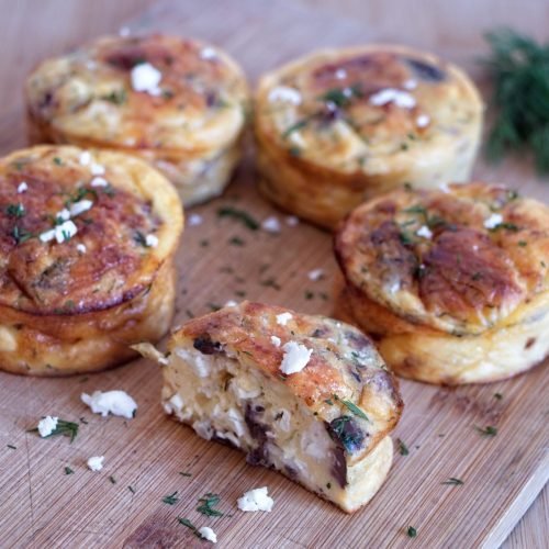 Low carb cottage cheese muffins with feta, dill and lemon on a wooden board