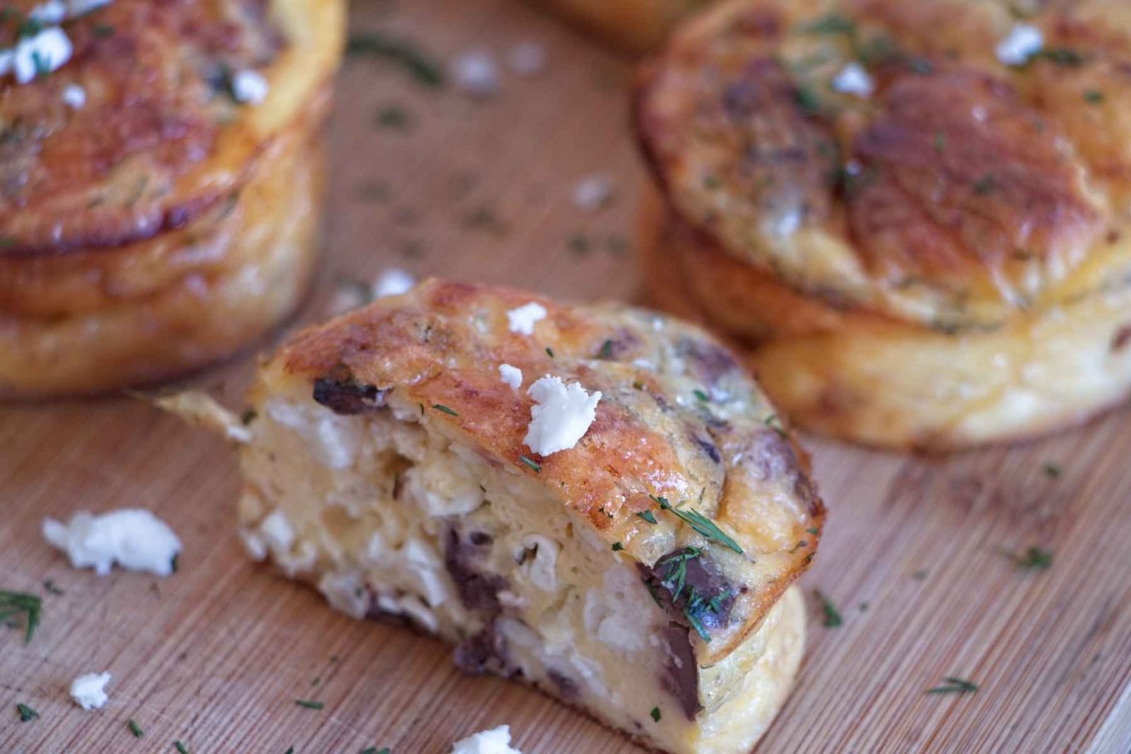 Low carb cottage cheese muffins showing the interior texture with feta, olives and herbs
