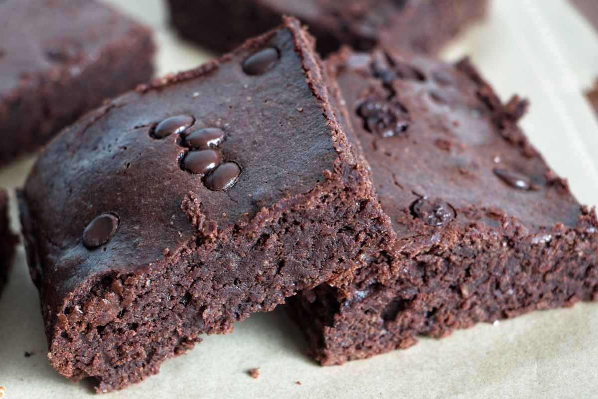 Protein brownies stacked to show a dense, fudgy chocolate crumb.