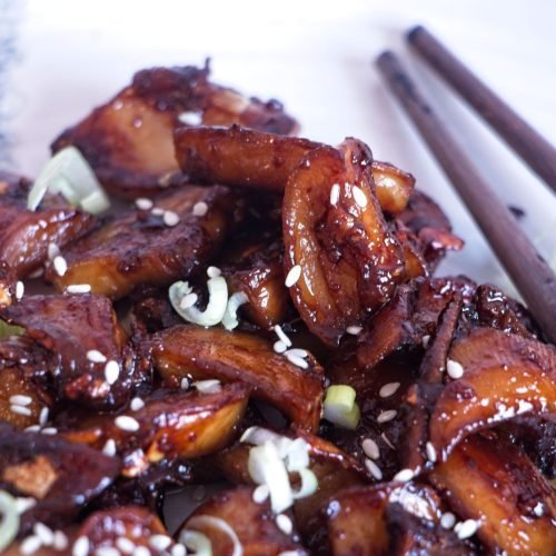 Sticky king oyster mushrooms coated in a garlic soy miso glaze, finished with spring onions and sesame seeds
