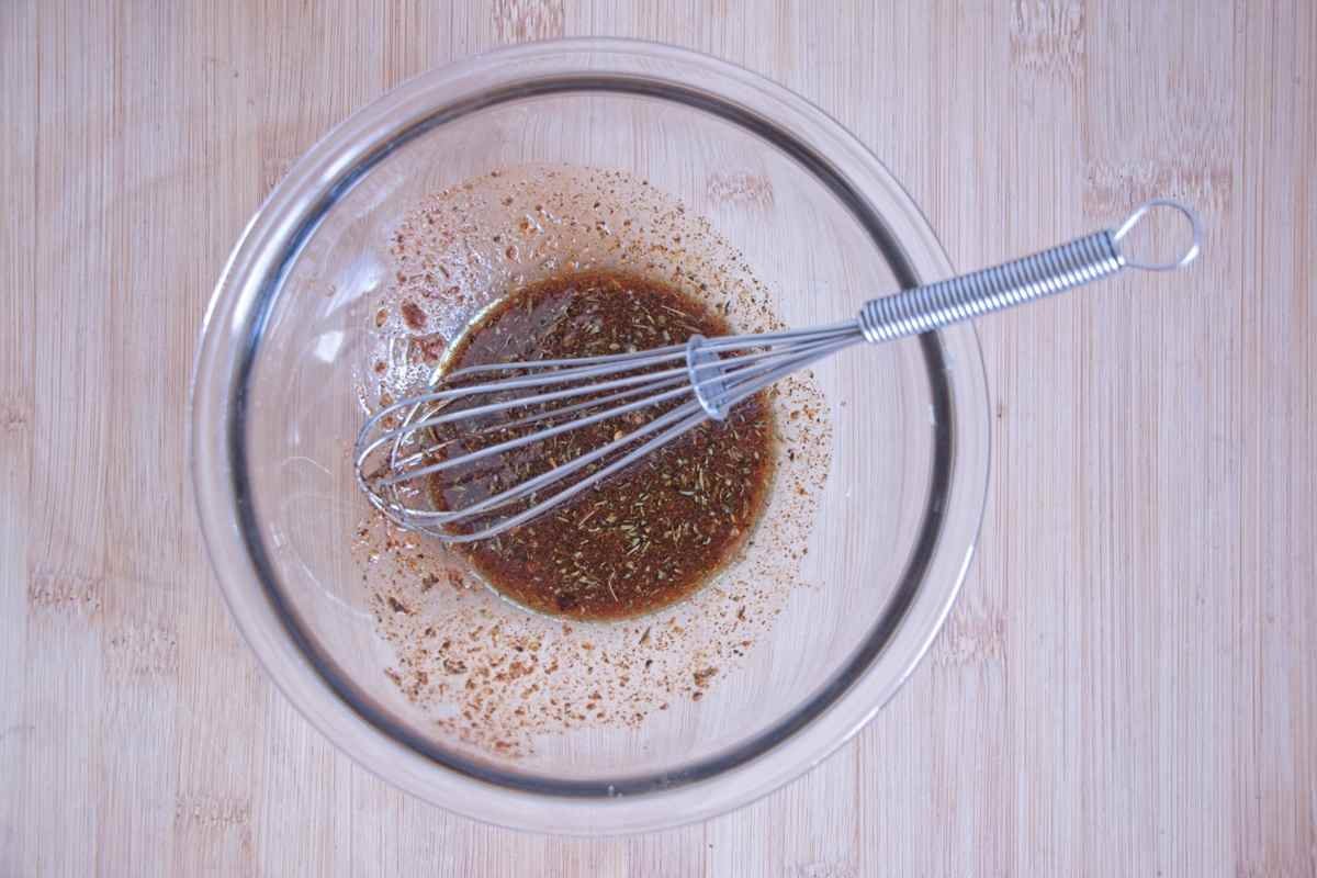 Soy sauce and spice marinade whisked in a glass bowl for mushroom bacon.