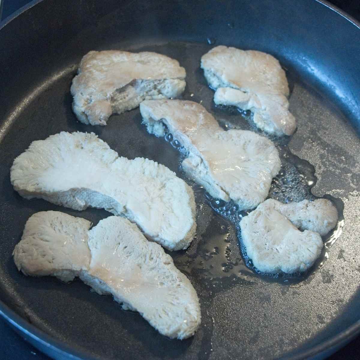 Squeezing water out of mushrooms at the start of cooking before browning