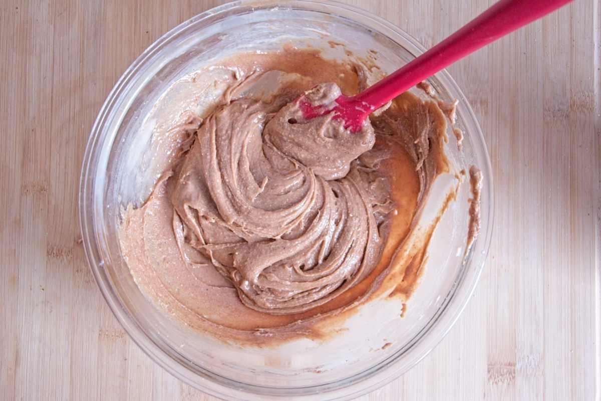 Protein caramel being mixed in a bowl with a spatula until smooth and evenly combined