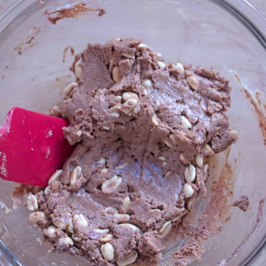 Peanut and date caramel mixture with chopped roasted peanuts folded through, ready to spread over the nougat base.