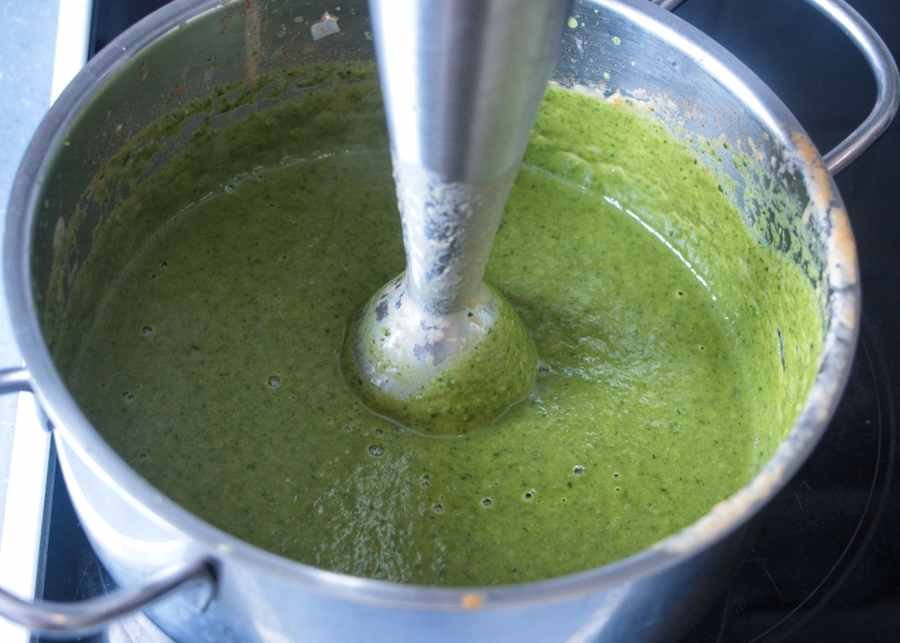 blending wild garlic ketchup in a saucepan with an immersion blender