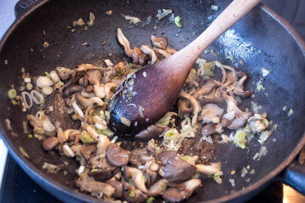 oyster mushrooms and onions cooking in a pan to build the stroganoff base