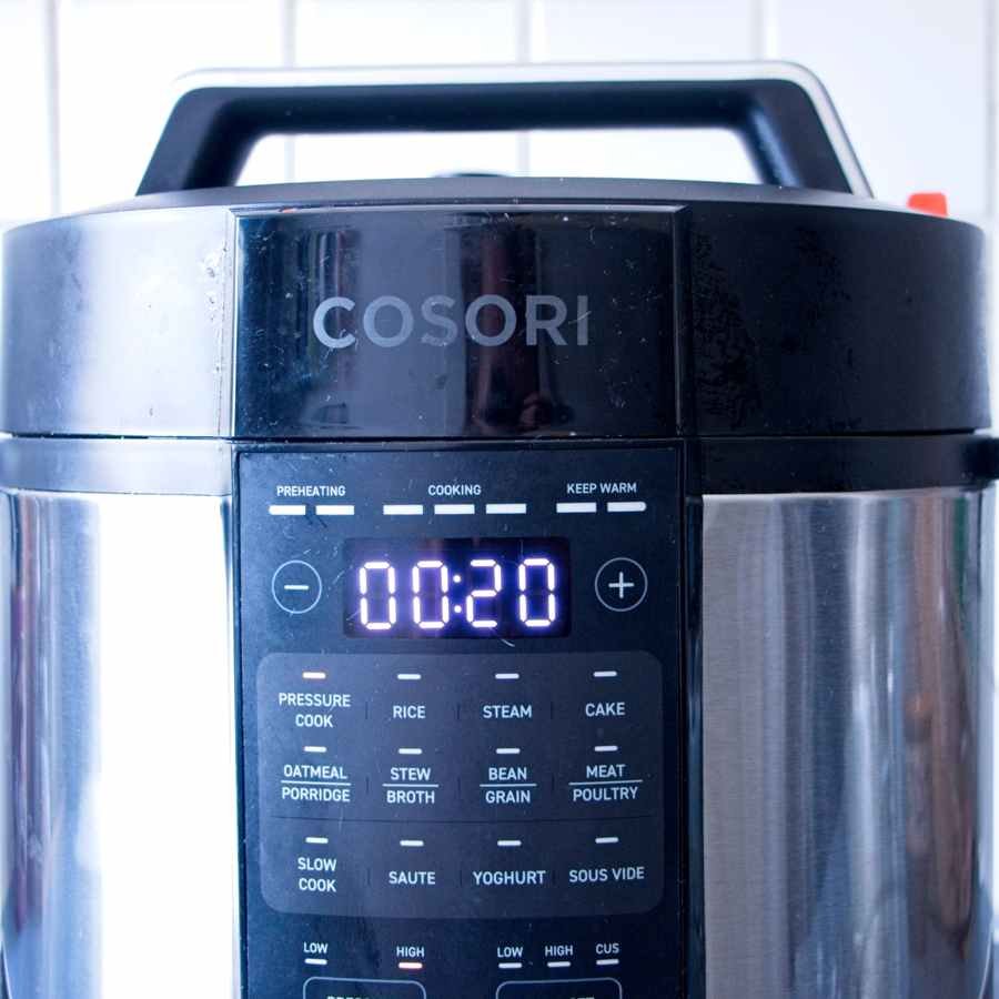 Electric pressure cooker display showing 20 minute cooking time