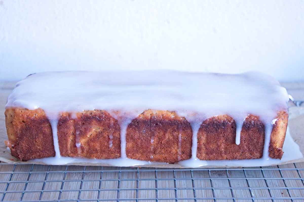 glazed lemon poppy seed loaf cake cooling on a rack