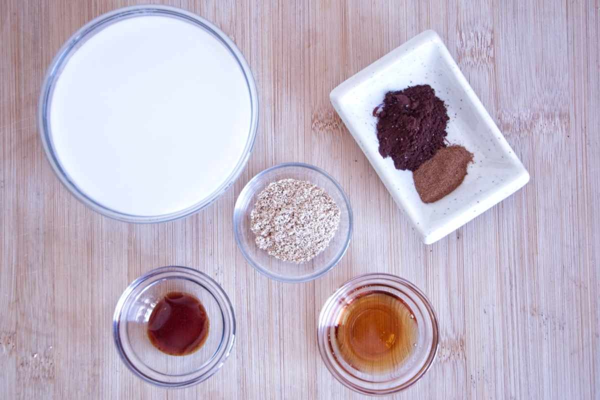 lion’s mane latte recipe ingredients including milk, lion’s mane powder, cacao, cinnamon, maple syrup, and vanilla