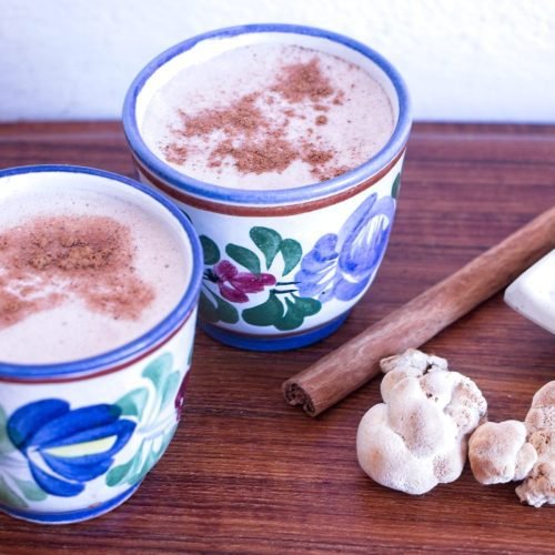 lion’s mane latte recipe served in ceramic cups with cinnamon, fresh lion’s mane mushrooms, and homemade mushroom powder