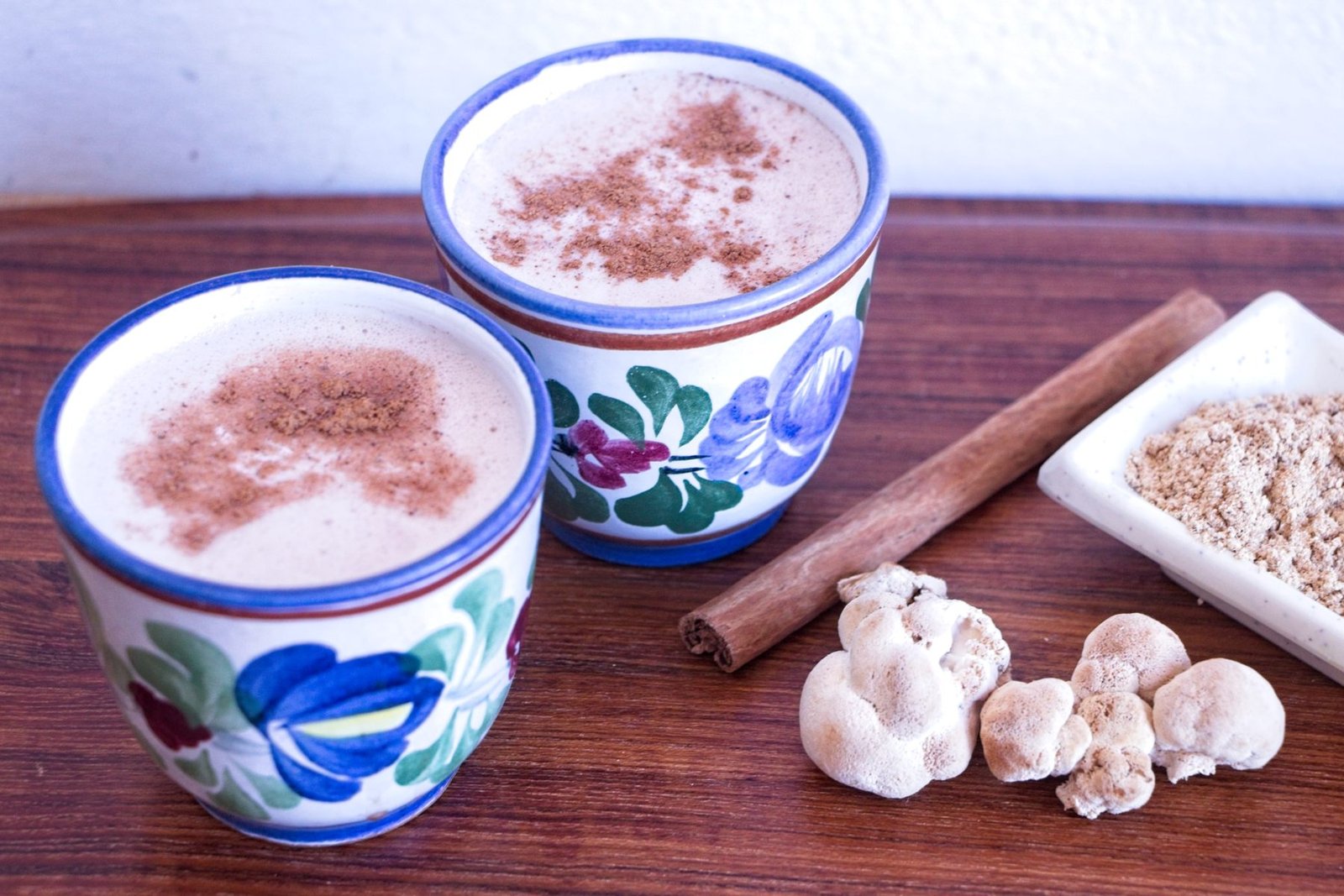 lion’s mane latte recipe served in ceramic cups with cinnamon, fresh lion’s mane mushrooms, and homemade mushroom powder