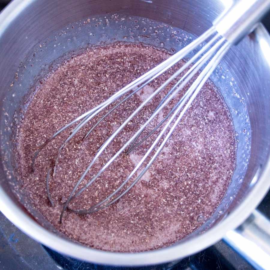 whisking cacao and lion’s mane powder in saucepan to make mushroom latte base