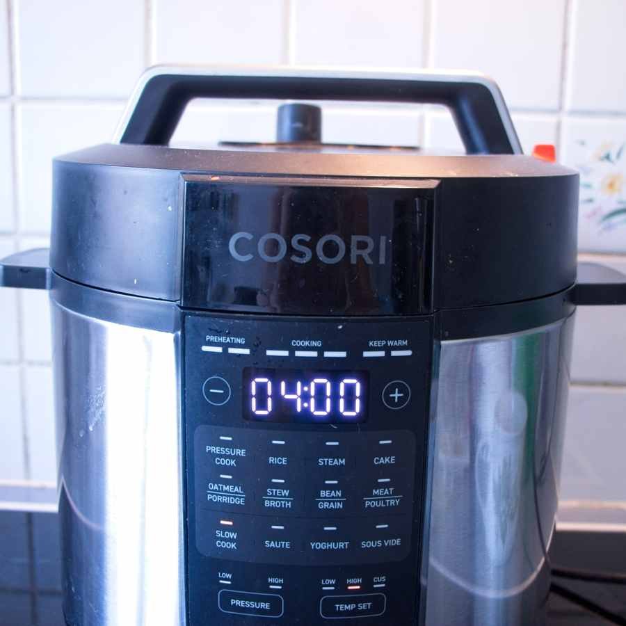 Cosori multi cooker set to slow cook mode for preparing mushroom stroganoff