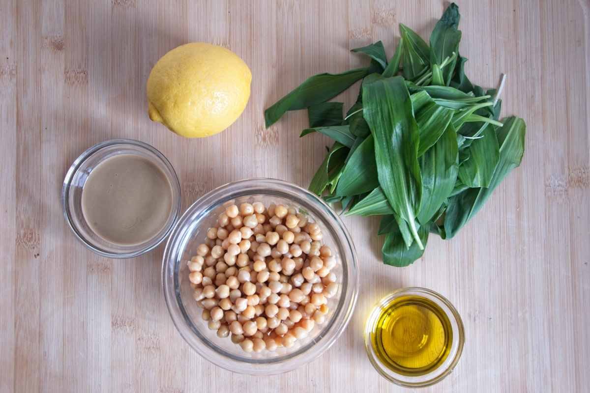 wild garlic hummus ingredients including chickpeas, tahini, lemon, olive oil, and fresh wild garlic