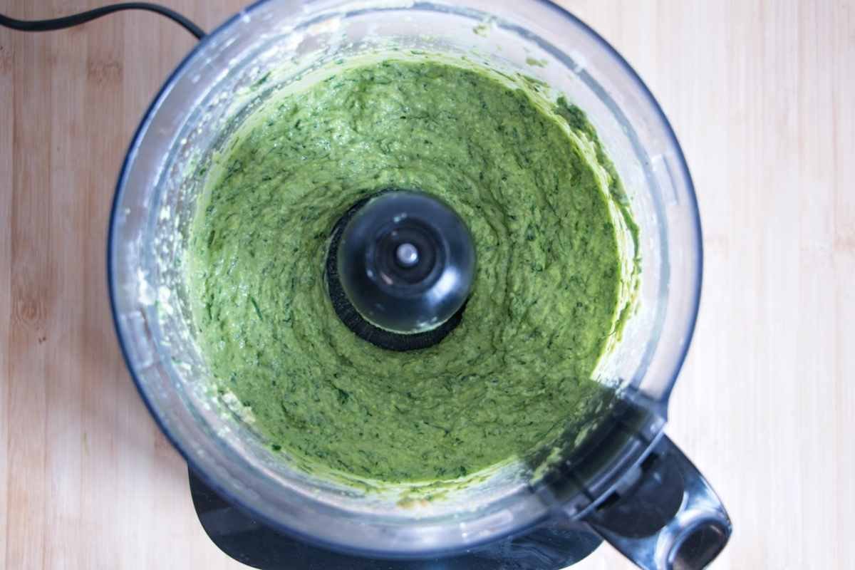 wild garlic hummus blending in food processor showing smooth green mixture