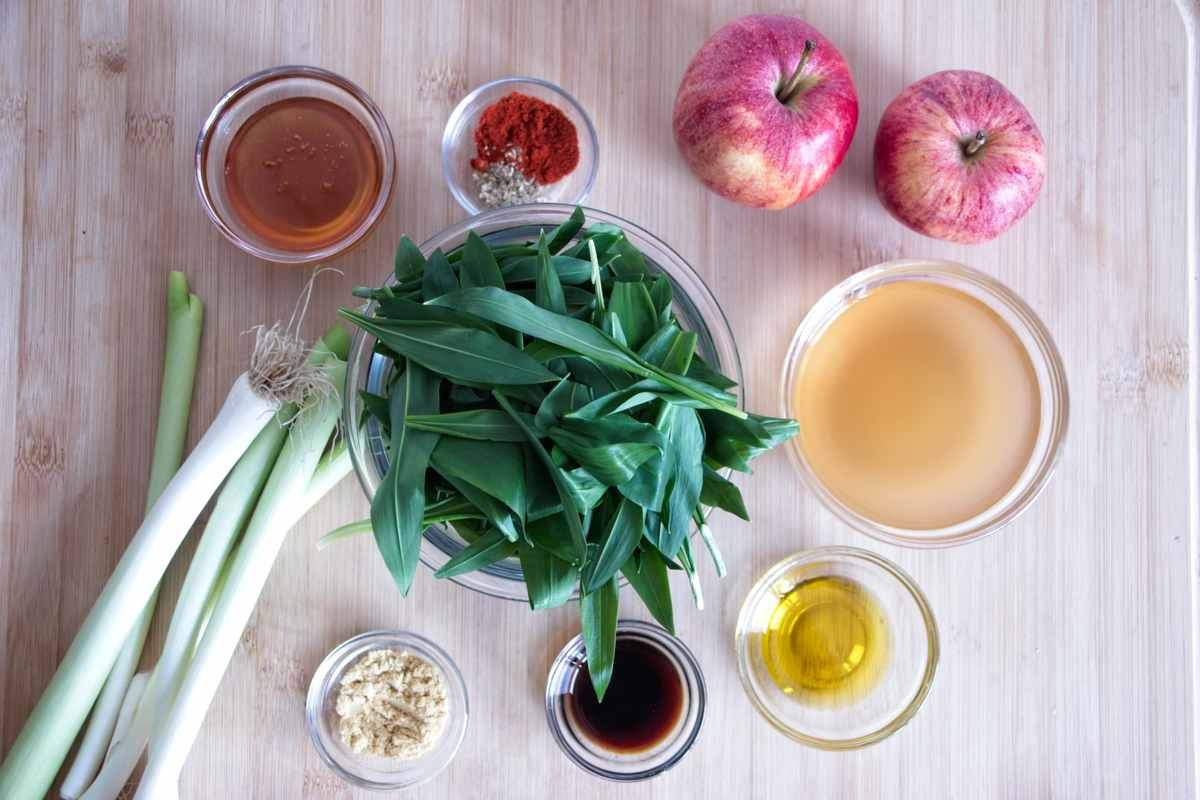 ingredients for wild garlic ketchup including apples, wild garlic leaves, vinegar, spring onions, honey, paprika, and mustard powder