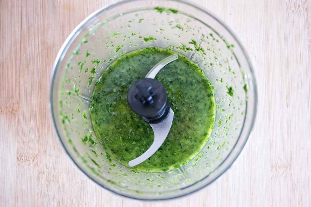 Blended wild garlic and olive oil in a food processor forming a smooth green mixture