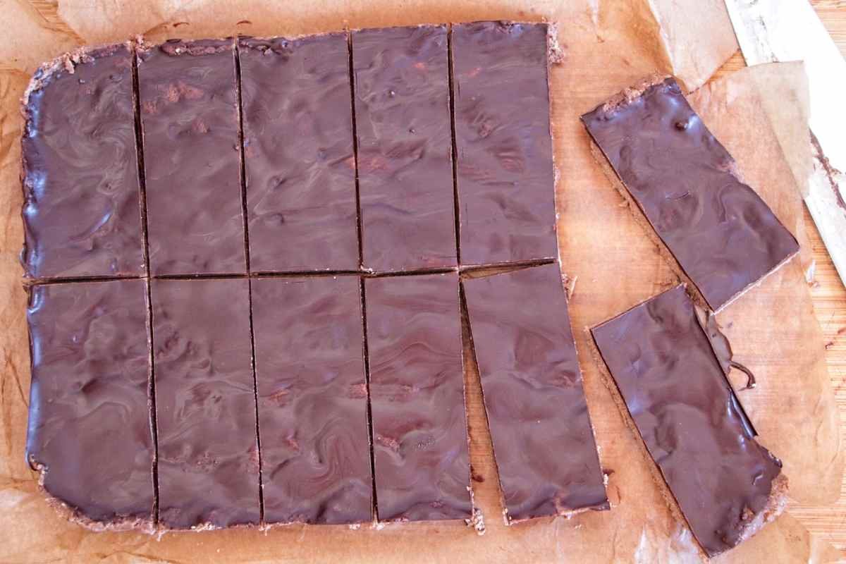 Chocolate peanut butter protein bars cut into squares with a smooth chocolate topping