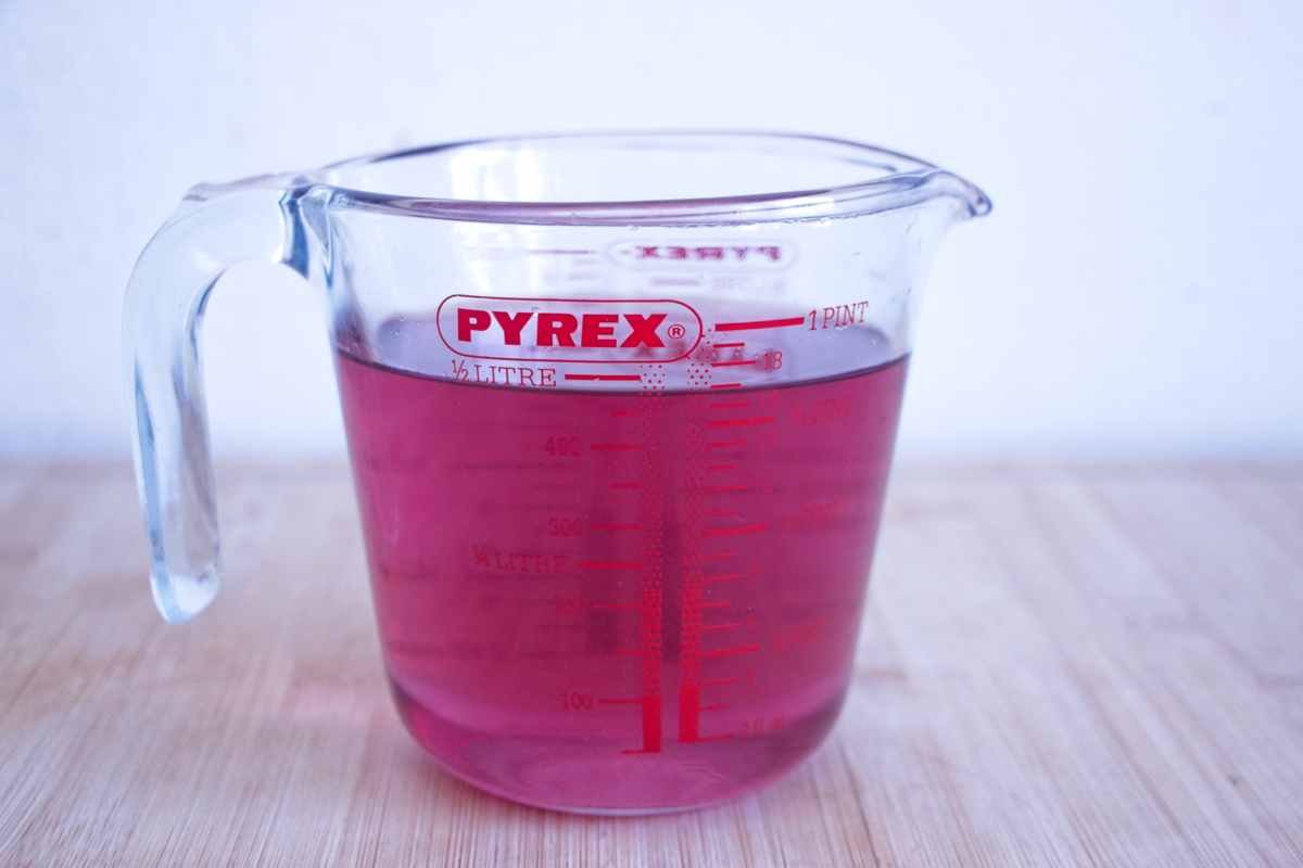 homemade violet syrup in a measuring jug ready for sorbet