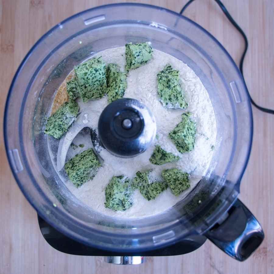 Cold wild garlic butter cubes added to flour in a food processor for making scone dough