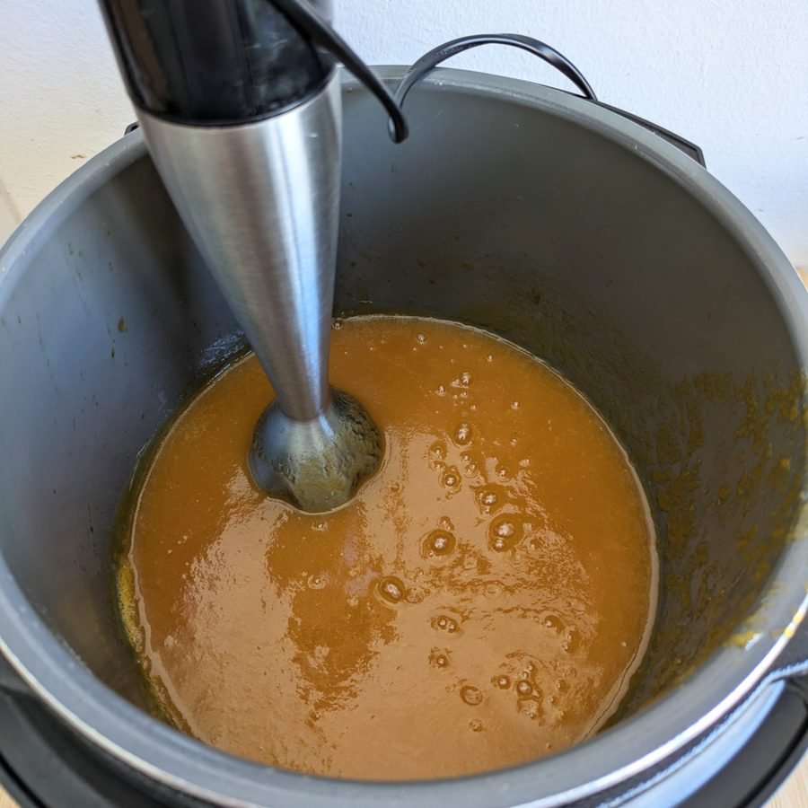 Blending cooked Mirabelle plums until smooth for homemade slow cooker spiced plum butter.