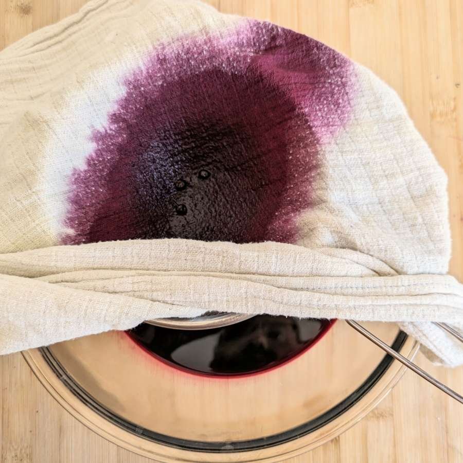Straining elderberry juice through a clean cloth