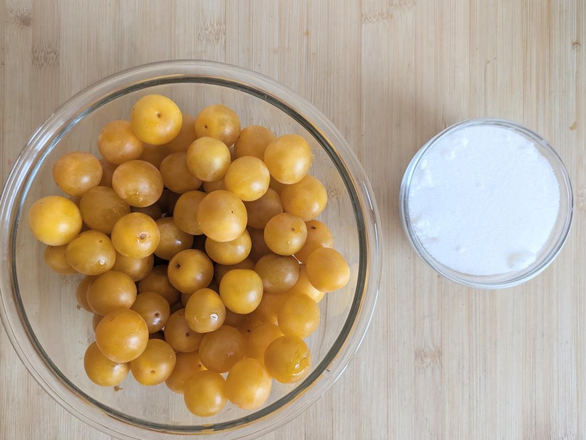 Fresh Mirabelle plums and sugar for making homemade plum cordial.