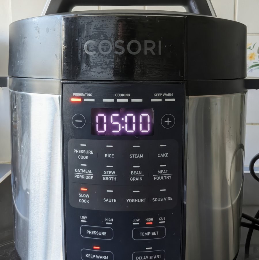 Slow cooker set to High for cooking homemade spiced plum butter.