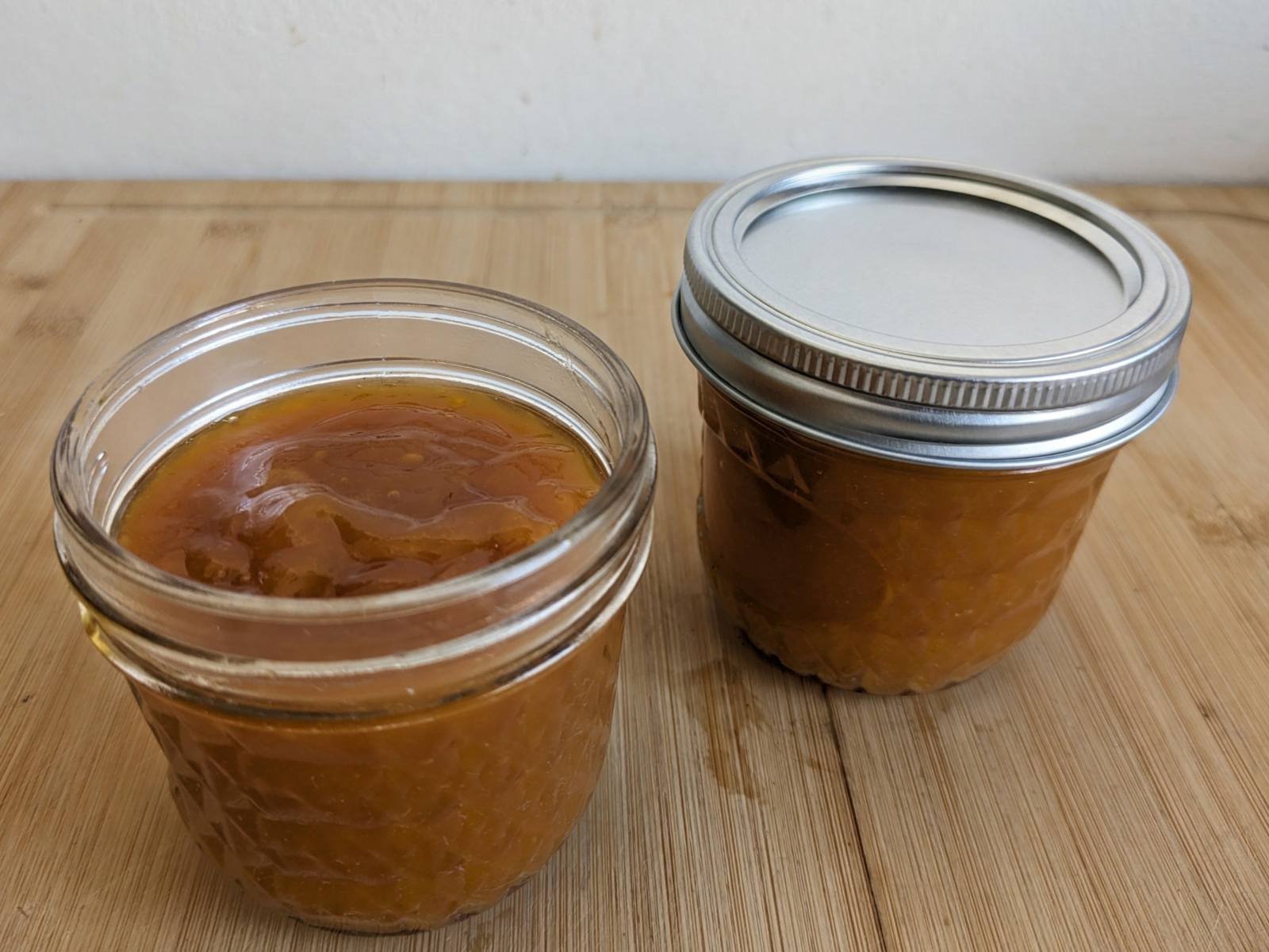 Two jars of homemade slow cooker spiced plum butter made with Mirabelle plums.