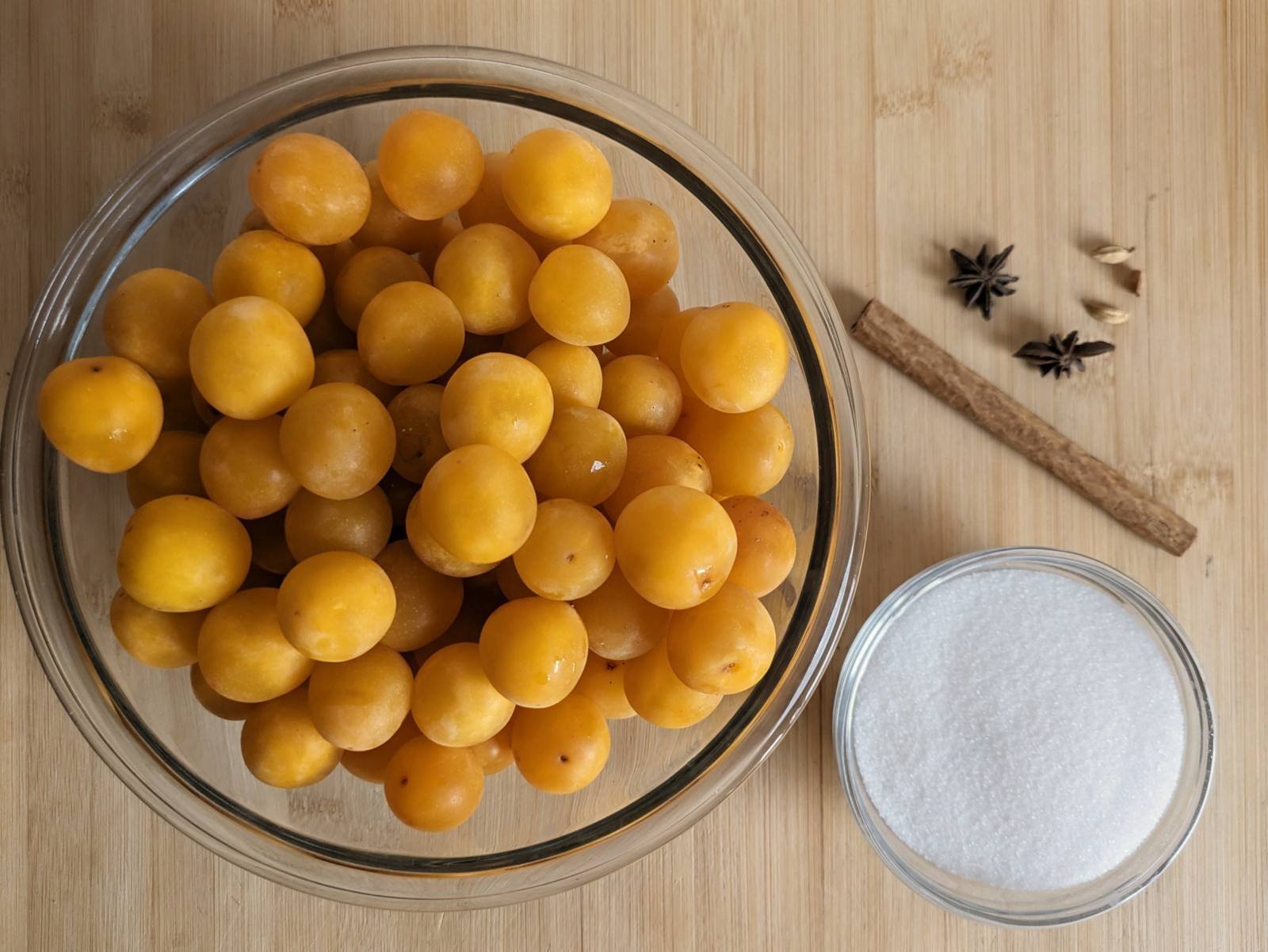 Ingredients for slow cooker spiced plum butter: Mirabelle plums, sugar, cinnamon, star anise and cardamom.