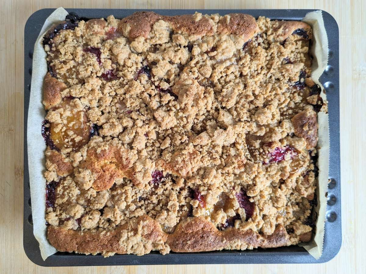 Baked prune plum crumble cake with a golden cinnamon streusel topping.