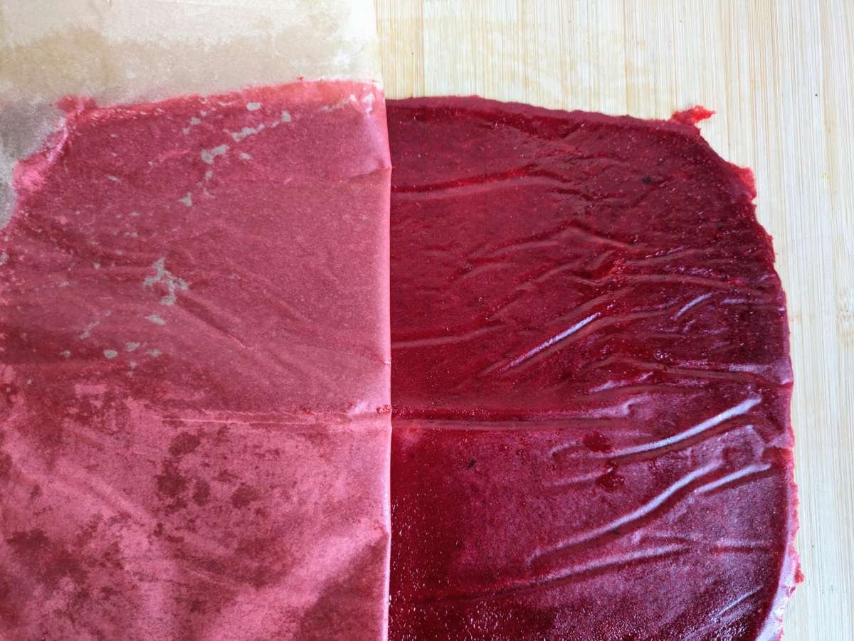 Baking parchment being peeled away from dried Cornelian cherry fruit leather.