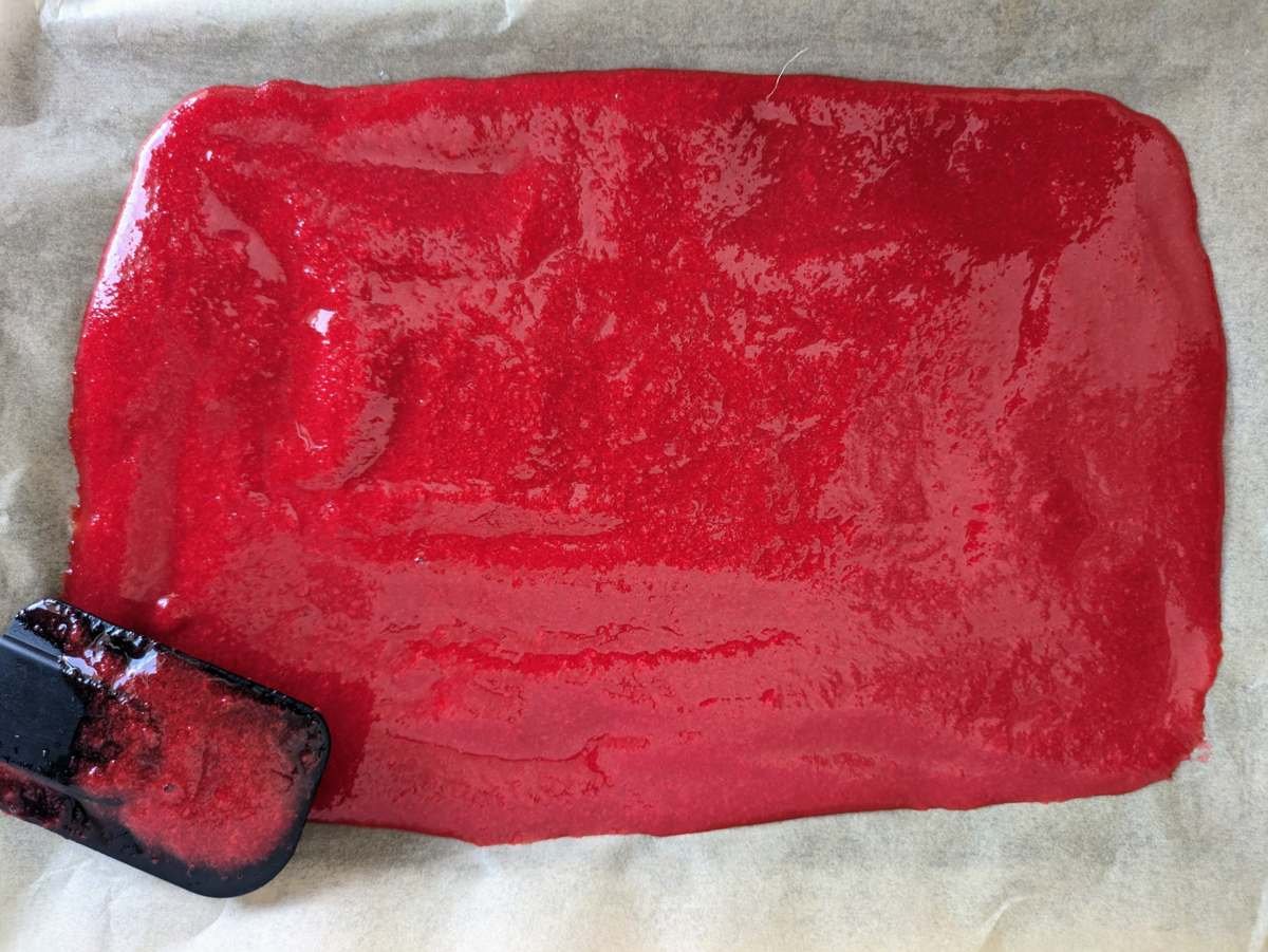 Cornelian cherry purée spread thinly on baking parchment before drying into fruit leather.